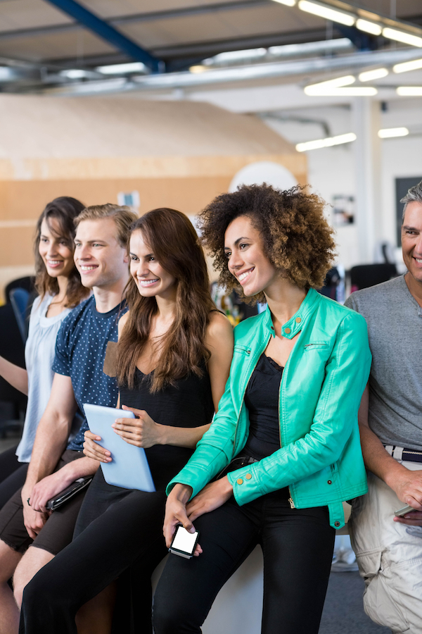 Group of businesspeople interacting during break time in office
